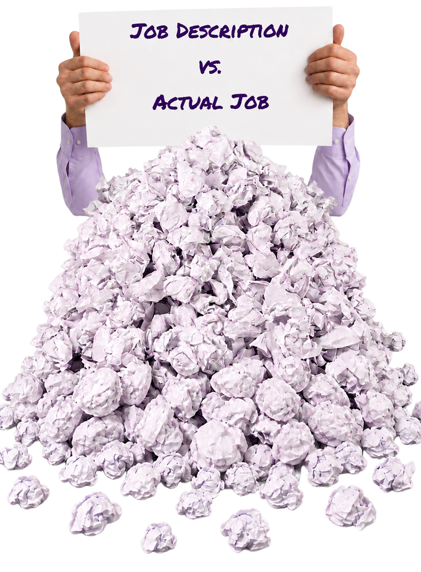 Person holding a sign reading 'Job Description vs. Actual Job' above a pile of crumpled paper spilling onto the floor